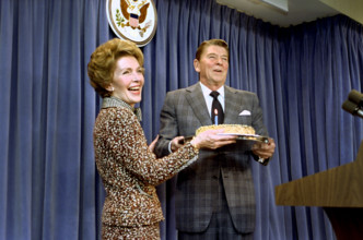 U.S. First Lady Nancy Reagan surprising U.S. President Ronald Reagan with a birthday cake during a