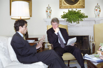 U.S. President Bill Clinton meeting with U.S. presidential senior advisor Rahm Emanuel in the Oval
