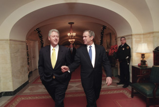 U.S. President Bill Clinton and U.S. President-Elect George W. Bush walking through White House,