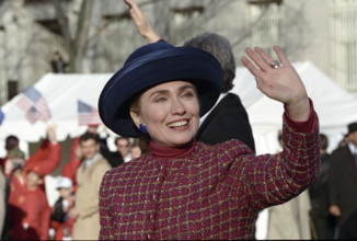 U.S. First Lady Hillary Rodham Clinton  and U.S. President Bill Clinton (partially hidden) walking