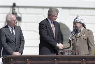 U.S. President Bill Clinton shaking hands with Palestine Liberation Organization Chairman Yasser