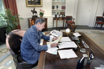 U.S. President Ronald Reagan working on an upcoming speech to the nation in the Oval Office of the