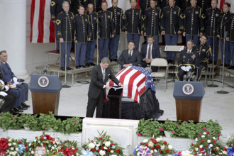 U.S. President Ronald Reagan presenting Congressional Medal of Honor before casket as Caspar