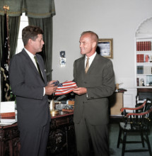 U.S. President John F. Kennedy receiving gift of an American flag from astronaut Lieutenant Colonel