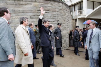 U.S. President Ronald Reagan waving to crowd outside Hilton Hotel shortly before assassination