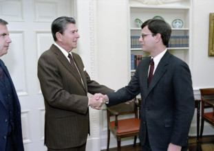 U.S. President Ronald Reagan greeting John Roberts during a photo opportunity with members of the