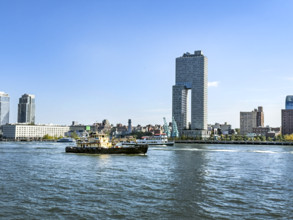 Circle Line ferry and tugboat in East River against Williamsburg cityscape, Brooklyn, New York