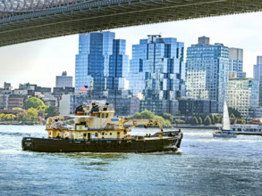 Tugboat in East River with Williamsburg cityscape in background, Brooklyn, New York City, New York,