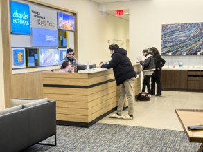 Customers being assisted at service counter, Charles Schwab & Company, Inc., 915 Broadway,
