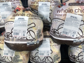 Packaged whole chicken display at grocery store