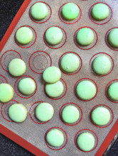High angle view of homemade macaroons on rubber baking sheet