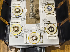 High angle view of dining room table set for formal dinner