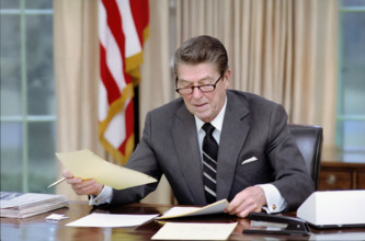 U.S. President Ronald Reagan on first day in administration in Oval Office, White House,