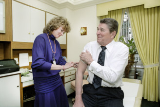 U.S. President Ronald Reagan getting a shot in White House doctors office, Washington, D.C., USA,