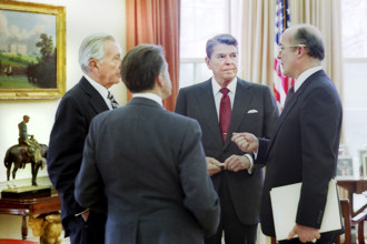 U.S. President Ronald Reagan (2nd right) meeting in the White House Oval Office with staff (L-R)