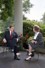 U.S. President Ronald Reagan and British Prime Minister Thatcher talk on patio outside White House