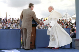U.S. President Ronald Reagan shaking hands with Pope John Paul II at Miami International Airport,