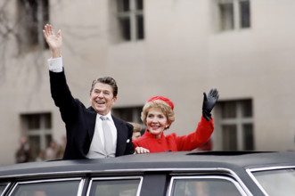U.S. President Ronald Reagan and U.S. First Lady Nancy Reagan waving from limousine during