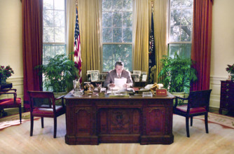U.S. President Ronald Reagan working in White House Oval Office, Washington, D.C., USA, President