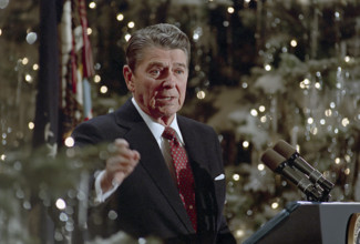 U.S. President Ronald Reagan speaking at podium during his final press conference, White House East
