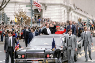 U.S. President Ronald Reagan and U.S. First Lady Nancy Reagan waving from presidential limousine