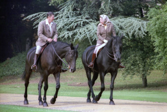 U.S. President Ronald Reagan riding horses with Queen Elizabeth II during visit to Windsor Castle,