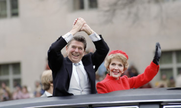 U.S. President Ronald Reagan and U.S. First Lady Nancy Reagan waving from presidential limousine