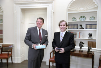 U.S. President Ronald Reagan with British musician Elton John in White House Oval Office,