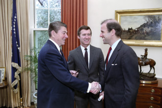 U.S. President Ronald Reagan meeting with U.S. senators Joseph Biden and William Cohen to discuss