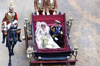 Prince Charles and Princess Diana riding in horse-drawn carriage during their Royal Wedding, high