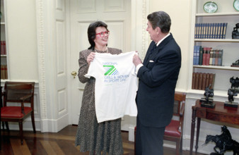 American tennis player Billie Jean King presenting U.S. President Ronald Reagan with a t-shirt in