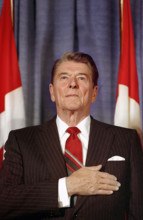 U.S. President Ronald Reagan with his hand over his heart during speech to the Empire Club at G-7