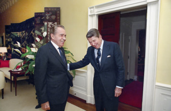 U.S. President Ronald Reagan laughing with former U.S. President Richard Nixon in White House