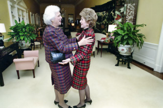 U.S. First Lady Nancy Reagan greeting U.S. Second Lady Barbara Bush in the White House private