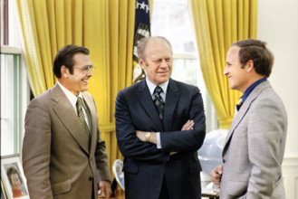 U.S. President Gerald R. Ford chatting with Chief of Staff Donald Rumsfeld and Rumsfeld’s Assistant