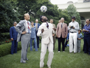 U.S. President Gerald R. Ford watching Pele head a soccer ball in the White House Rose Garden,