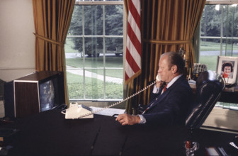 U.S. President Gerald R. Ford talking on telephone with Apollo-Soyuz crew members during docked