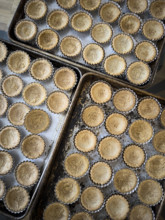 Pre-baked mini tart crusts in baking tin