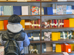 Person shopping for notebooks, Goods For The Study retail store, West Village, Manhattan, New York
