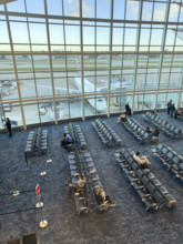 High angle view of travelers relaxing in departure lounge, Delta Airlines, Fort