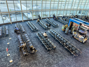 High angle view of travelers relaxing in departure lounge, Delta Airlines, Fort