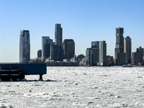 View of Jersey City, New Jersey, USA skyline across frozen Hudson River