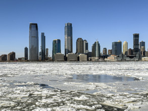View of Jersey City, New Jersey, USA skyline across frozen Hudson River