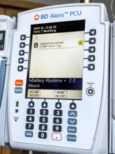 Close-up detail of BD Alaris PCU IV pump machine in hospital room