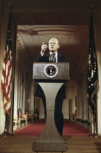 U.S. President Gerald R. Ford standing at lectern during first press conference, White House East