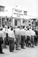 Draftees lined outside a building with a sign "Welcome to the U.S. Army", Fort Jackson, South