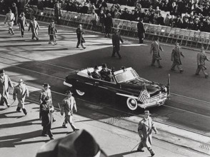 U.S. President Harry S. Truman and U.S. Vice President Alben Barkley wave to crowds their car