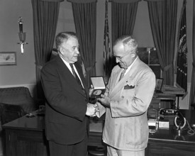 President Harry S. Truman (right) presents a Congressional Gold Medal, authorized by Congress, to U
