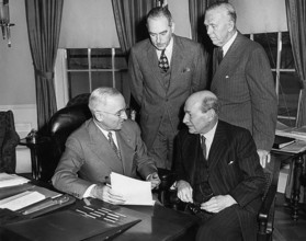 British Prime Minister Clement Attlee (seated right) meeting with President Harry S. Truman (seated