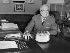 U.S. President Harry S. Truman receiving a cake for his 67th birthday, White House Oval Office,